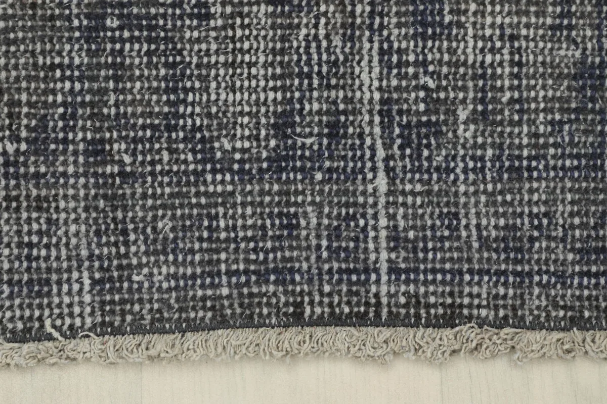 Detail of the short, aged fringes at one end of the hand-knotted runner