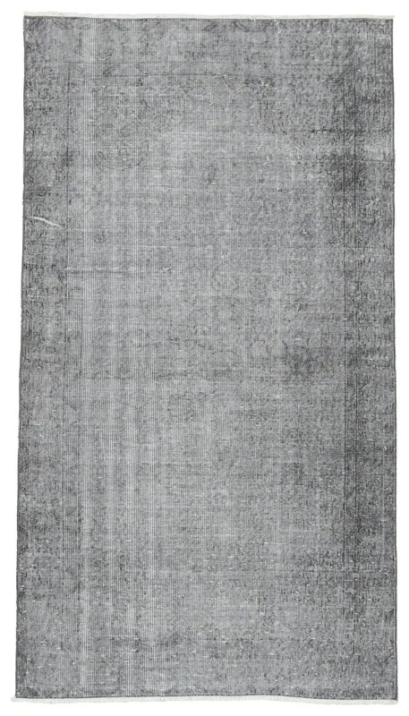Full top view of the charcoal gray distressed vintage Anatolian rug on a white background