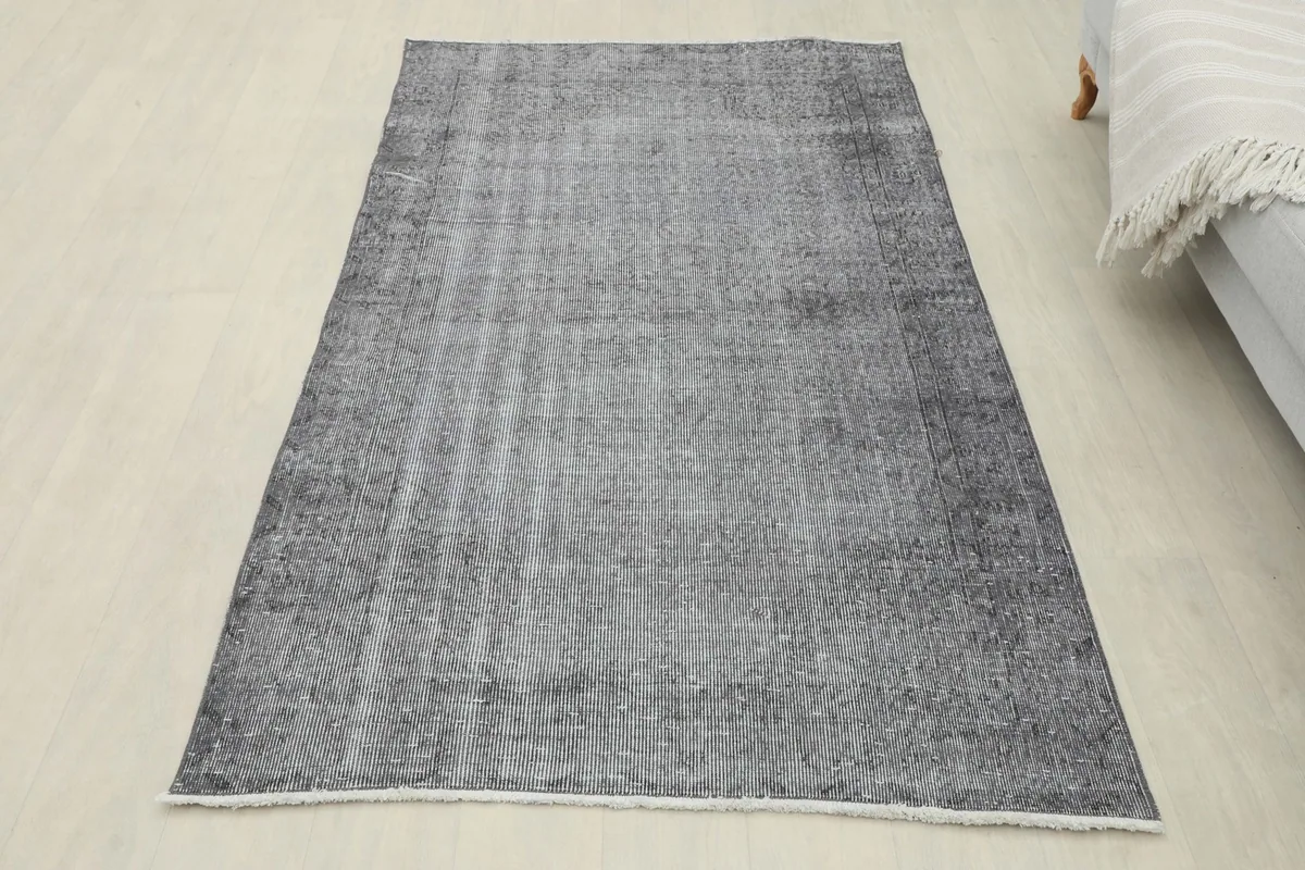 Overhead view of the charcoal gray rug in a room setting, showcasing its full size and color