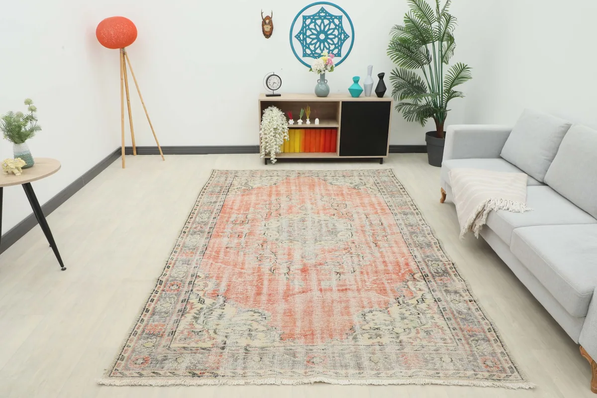 Overhead view of the vintage rug in a room, showcasing its full design and colors.