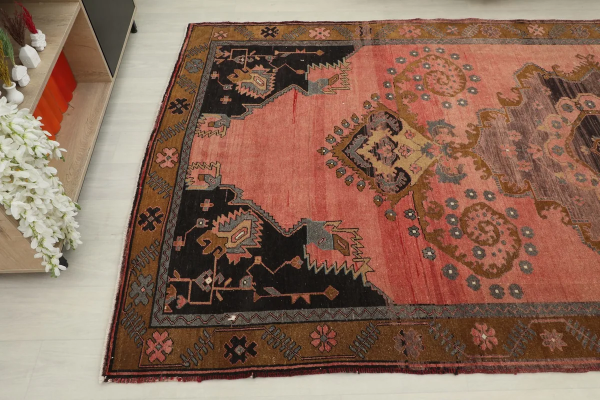 Angled view of the lower section of the rose rug, showing corner details and motifs