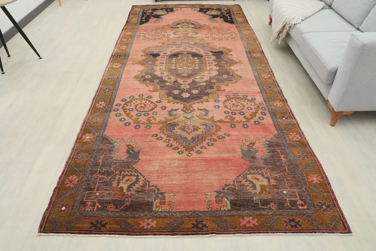Full room view of the long rose runner rug extending through a spacious area