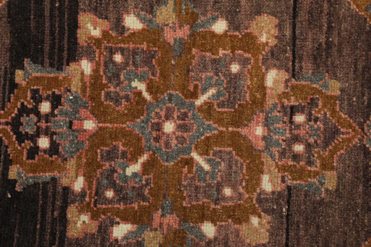 Close-up detail of the intricate gold and olive floral patterns within the central medallion