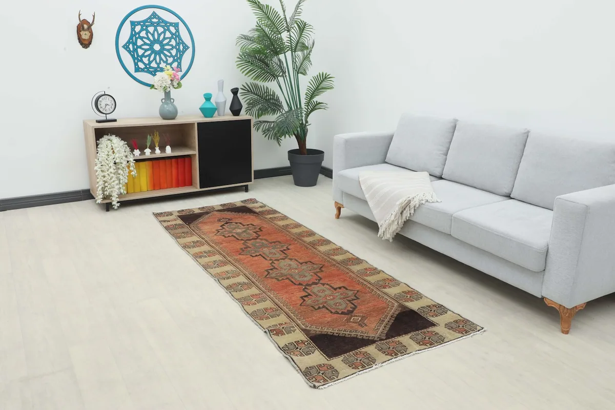 Runner rug displayed in a living room setting with a light gray sofa and wooden cabinet.
