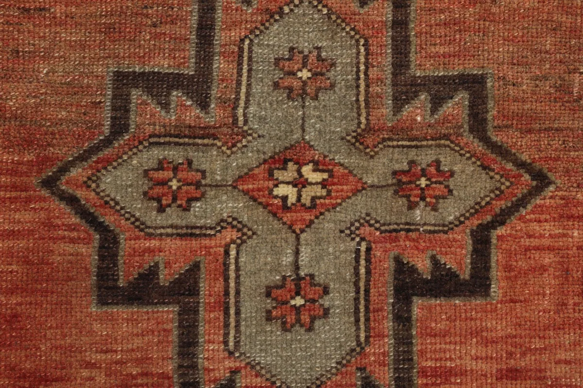 Close-up of a single central geometric motif, showing its intricate design and color variations.