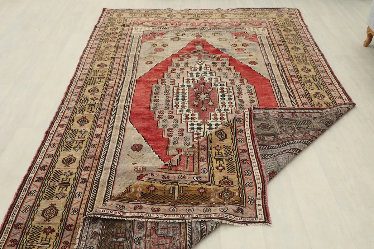 Partial view of the rug's back, revealing the hand-knotted construction and wool pile.