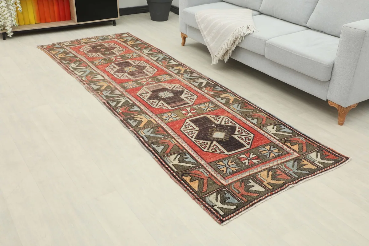 Vintage Anatolian runner rug displayed in a modern living space with a light gray sofa