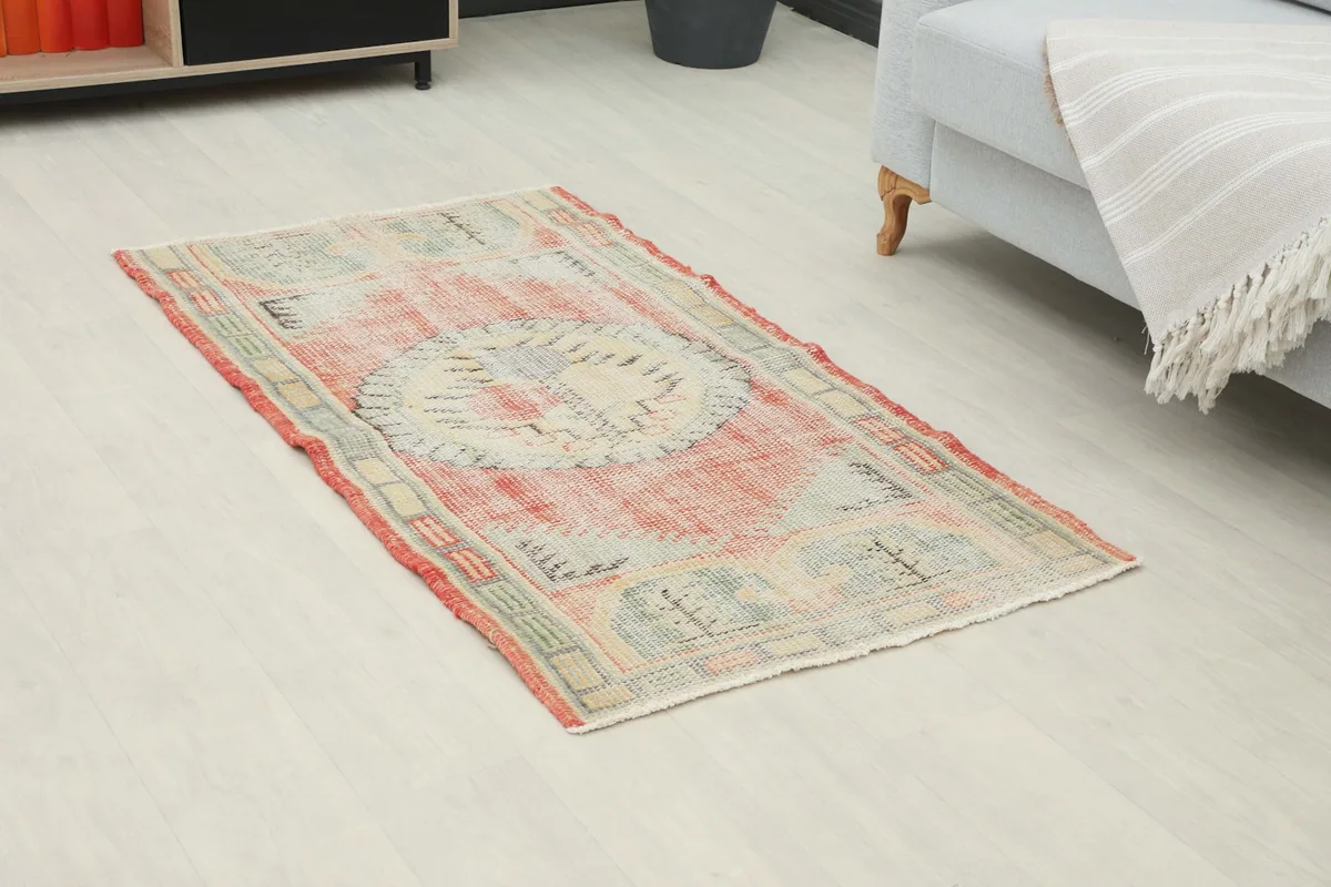 Angle view of the rust and ivory geometric rug on a light floor, enhancing a contemporary living space.