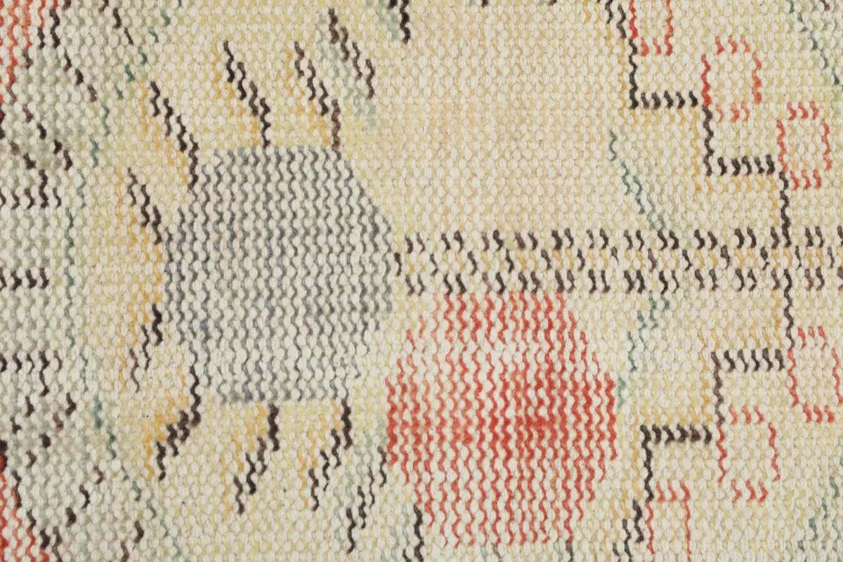 Close-up of the low wool pile and intricate hand-knotted weaving in the central design of the vintage rug.