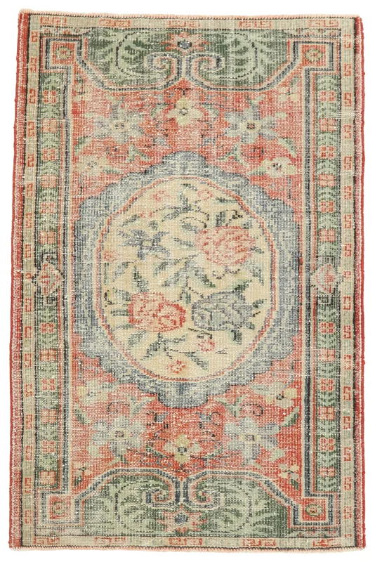 Full top view of the rust, green, and ivory vintage Anatolian rug on a white background