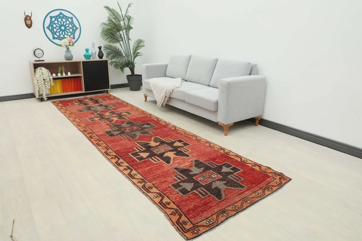 Red Anatolian Tribal Runner in a modern living space with a gray sofa