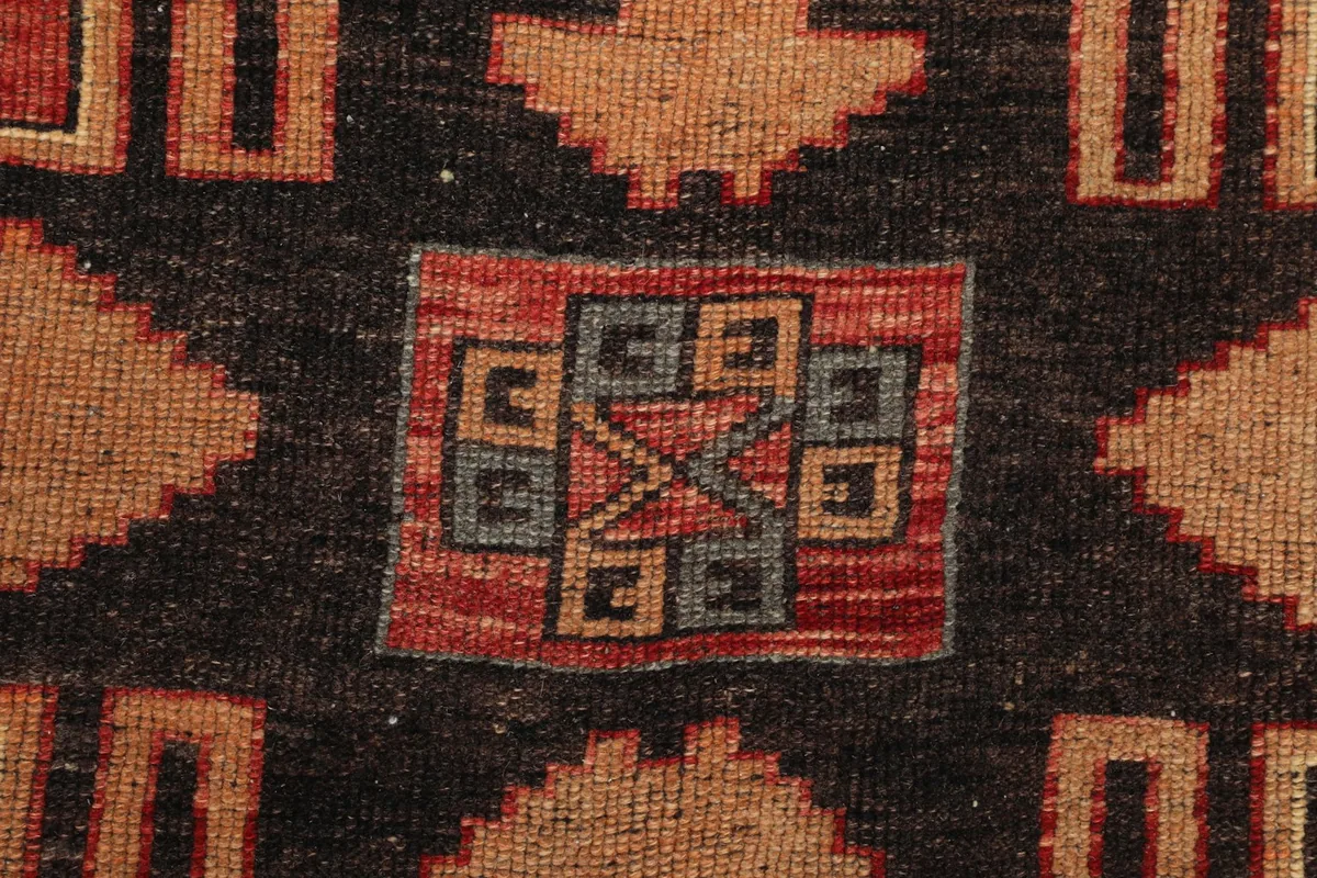 Extreme close-up of the hand-knotted wool pile and intricate central design