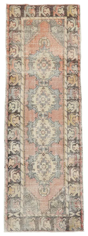 Full top view of the vintage rust and blue geometric runner rug on a white background