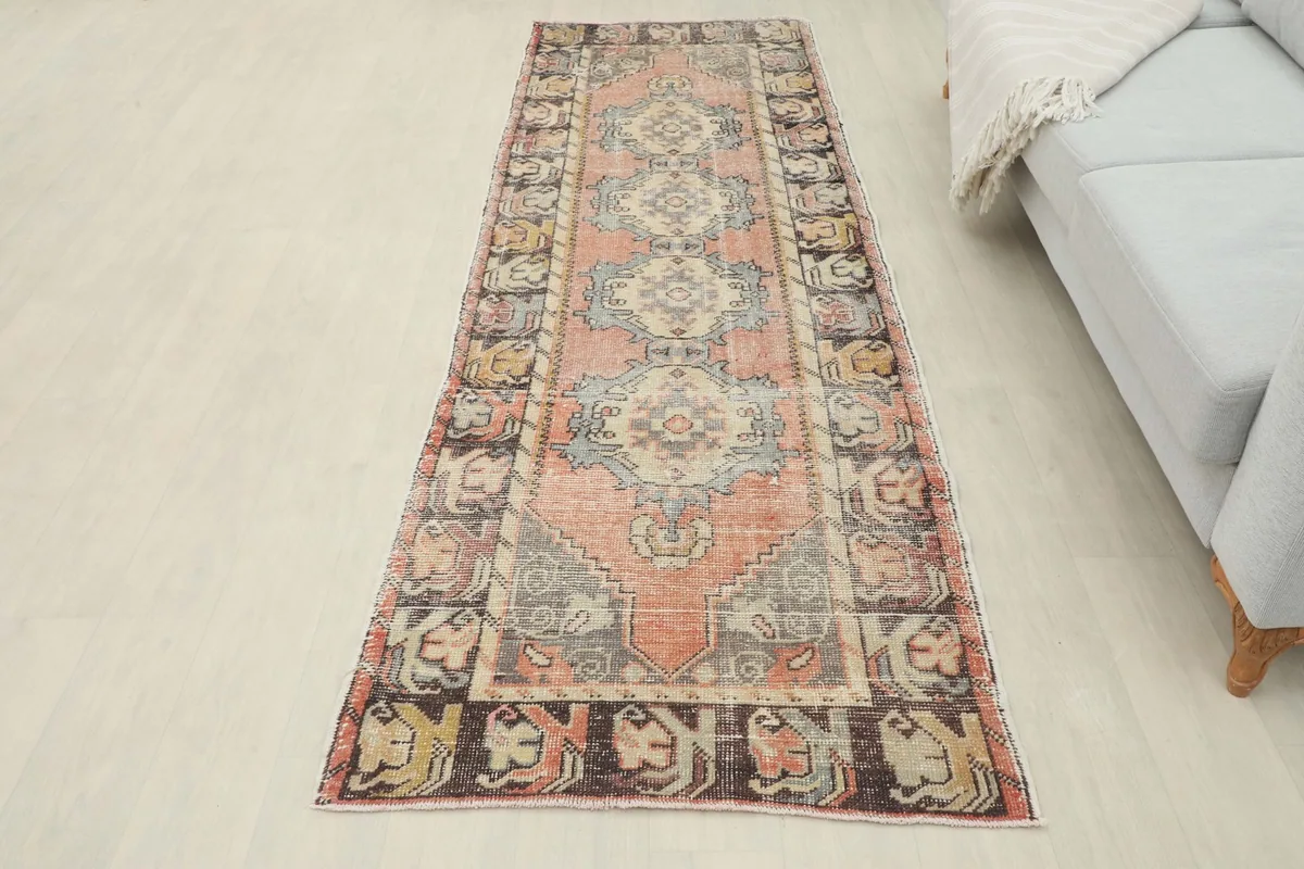 Full view of the rust and blue geometric runner rug in a room, showcasing its overall appearance