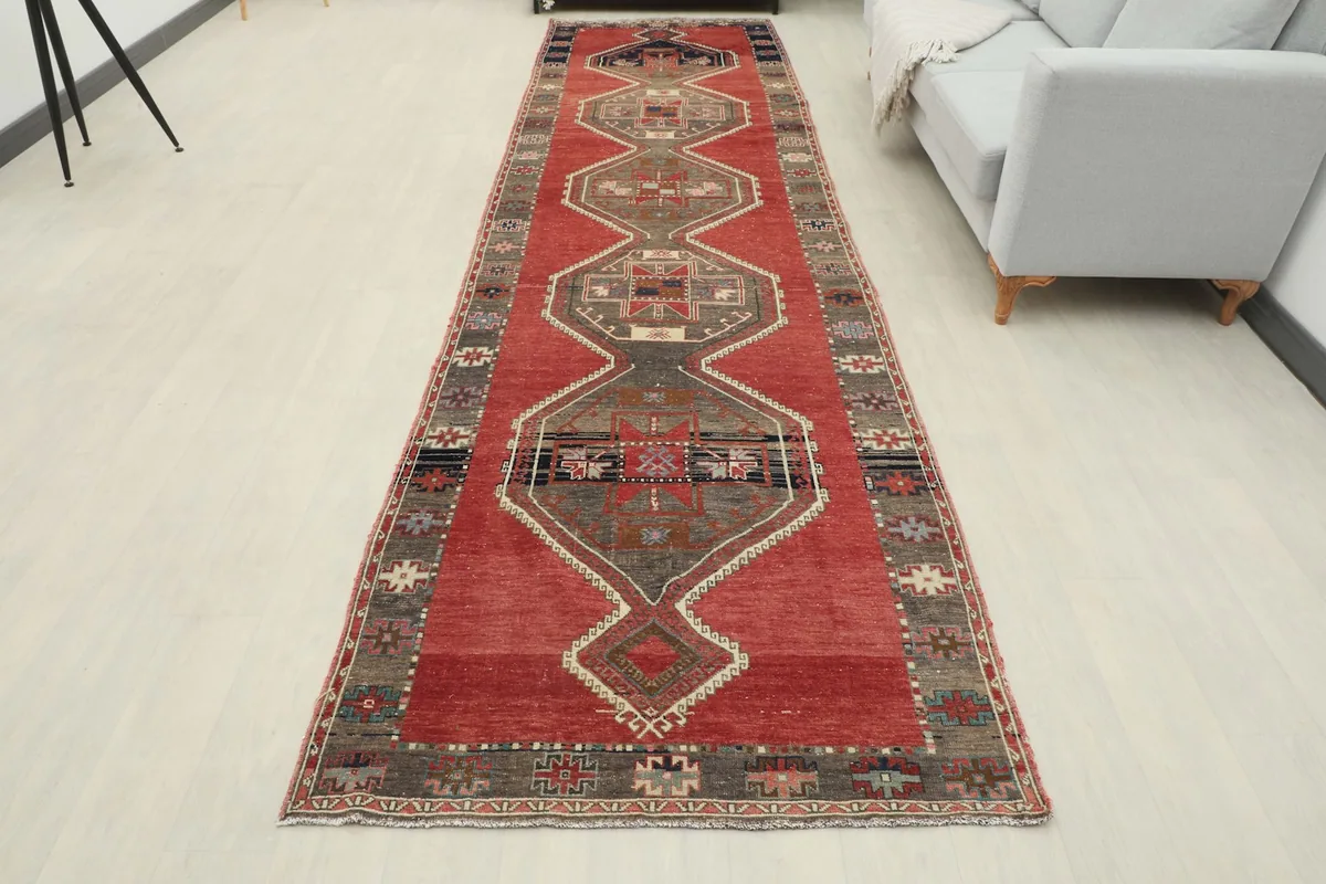 Full overhead view of the rust and gray runner rug in a modern room setting, highlighting its overall design.