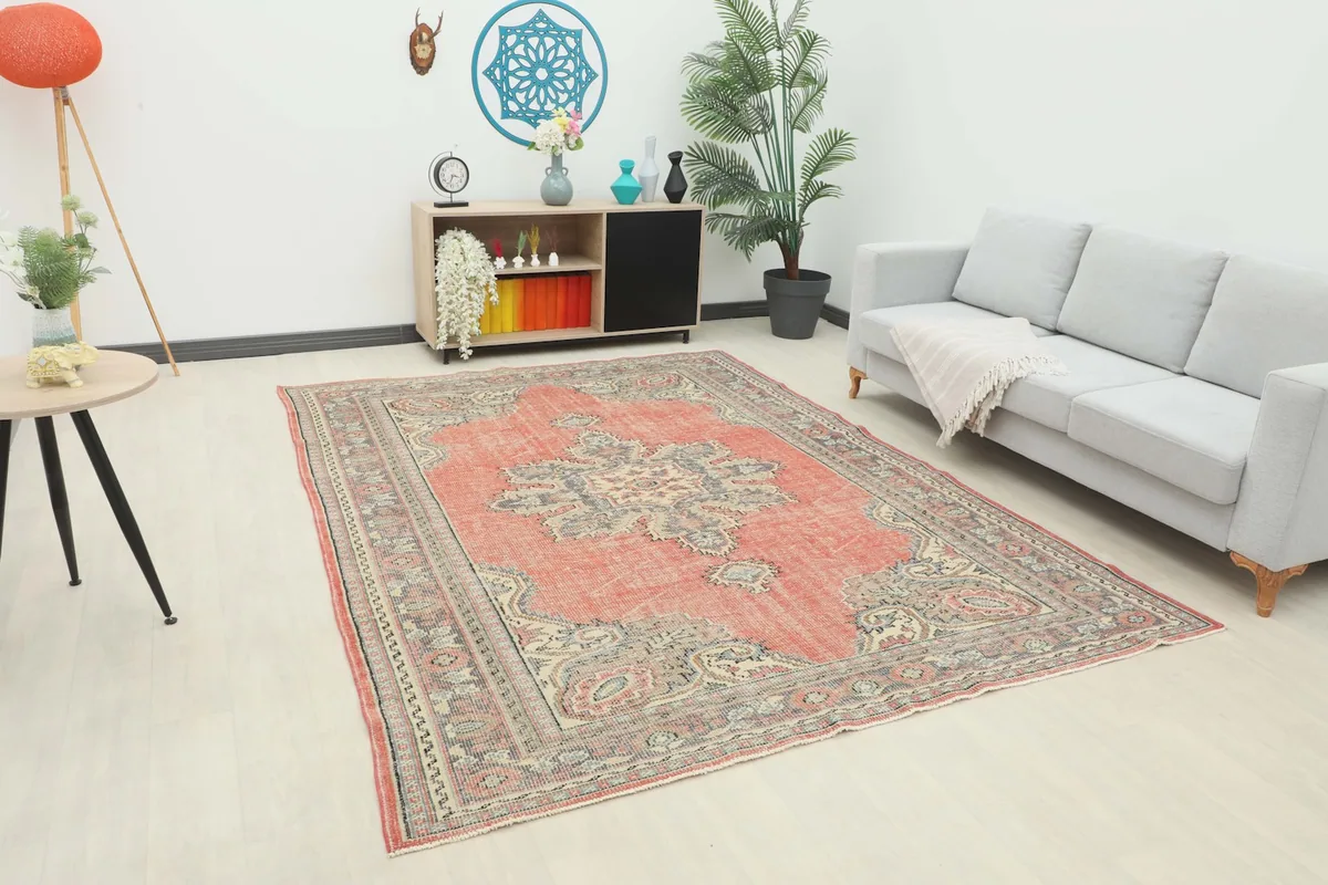 Anatolian rug displayed in a living room setting with a sofa and console
