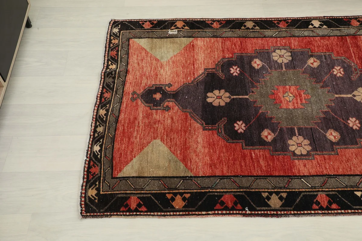Angled view of the lower part of the runner rug, highlighting the geometric patterns