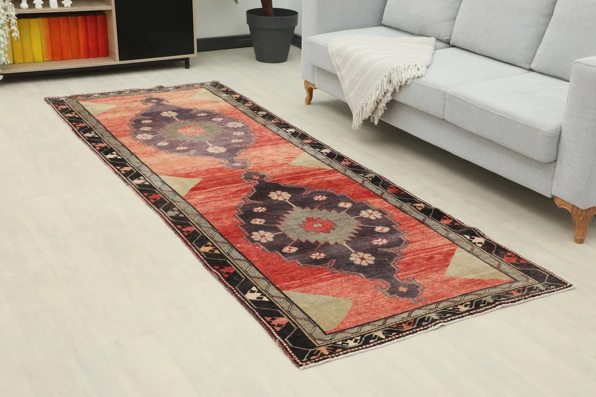 Angled view of the rust and navy runner rug in a modern living space