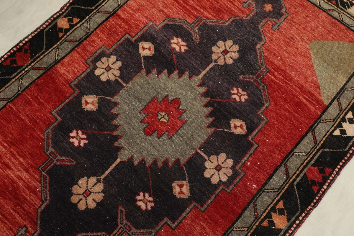 Detailed view of the central navy and gray medallion with rust and tan accents