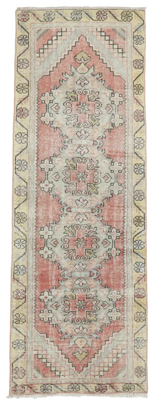 Full top view of the 3'1" x 9'1" vintage Anatolian runner rug with rose and beige colors