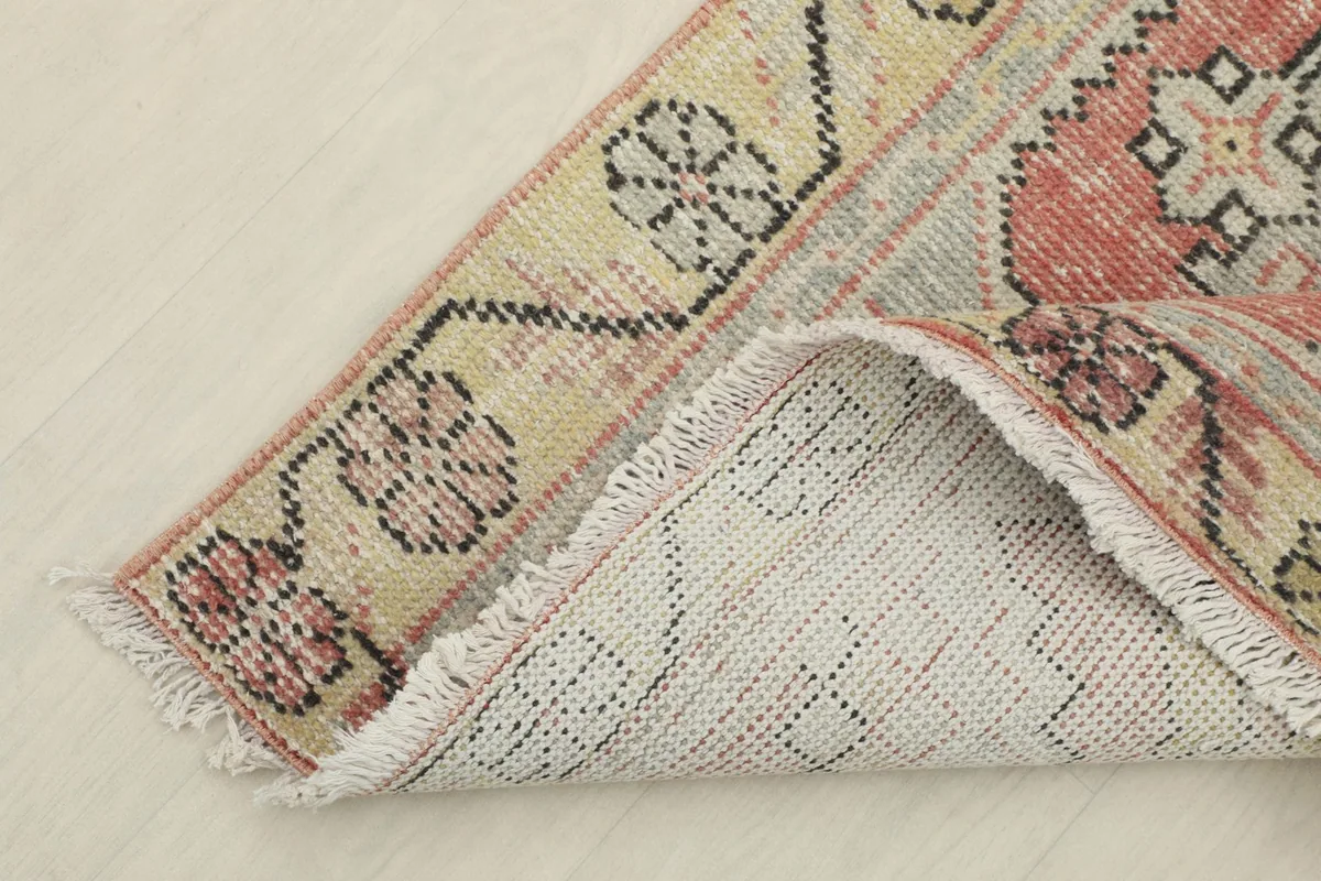 View of the back of the hand-knotted rug, revealing the cotton foundation and knotting