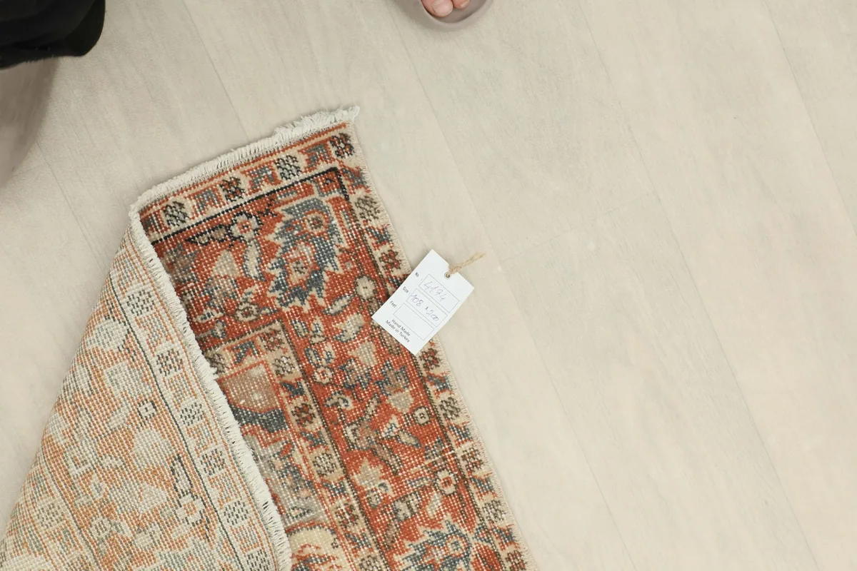 Overhead view of a folded corner with a product tag, indicating quality and origin