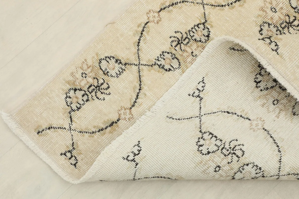 Close-up of the rug's reverse side, revealing the hand-knotted cotton foundation