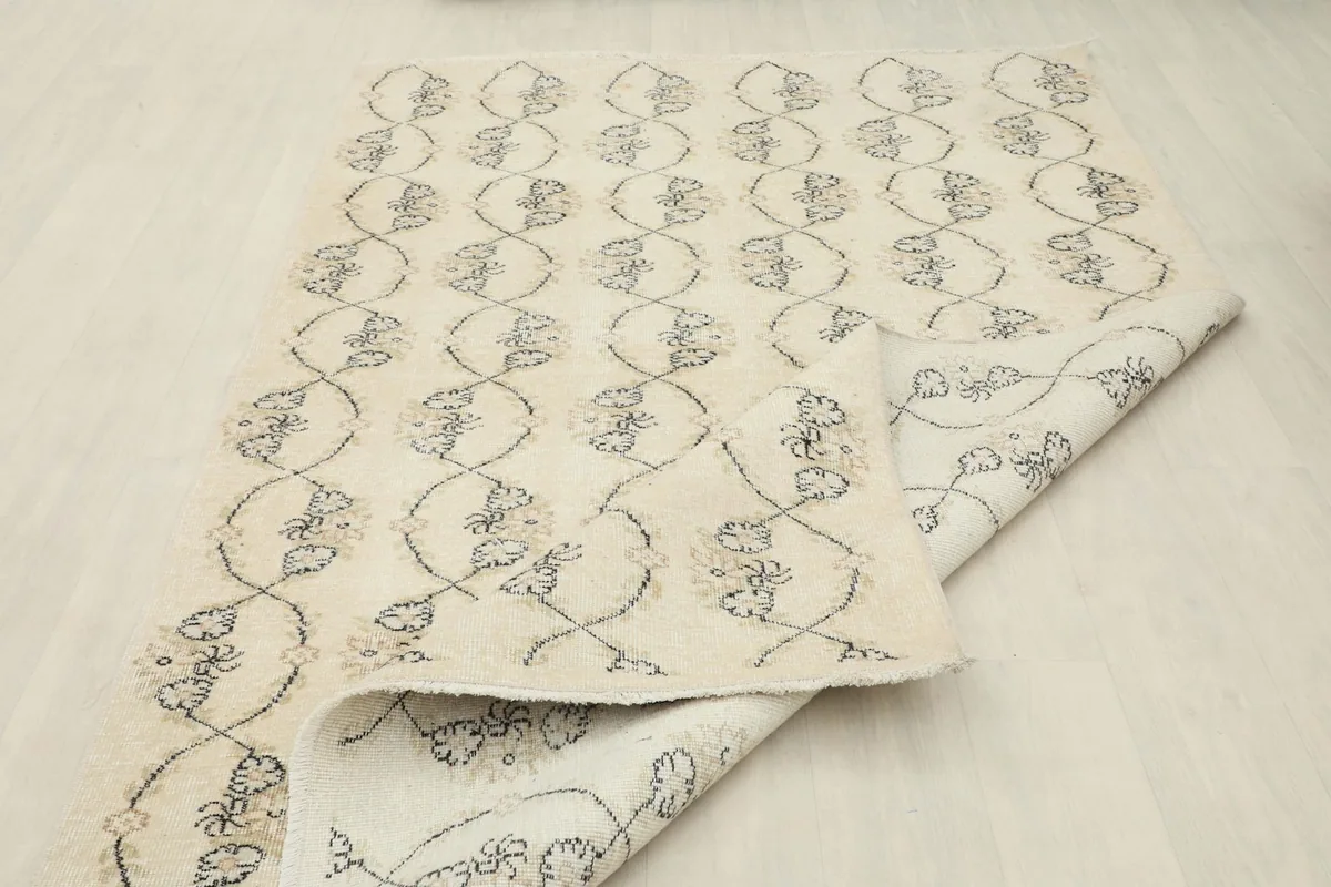 Folded view of the rug showing both the top pile and the cotton foundation on the reverse