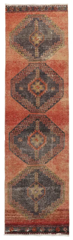 Full top view of the 2'7" x 9'6" rust and navy geometric runner rug on a white background
