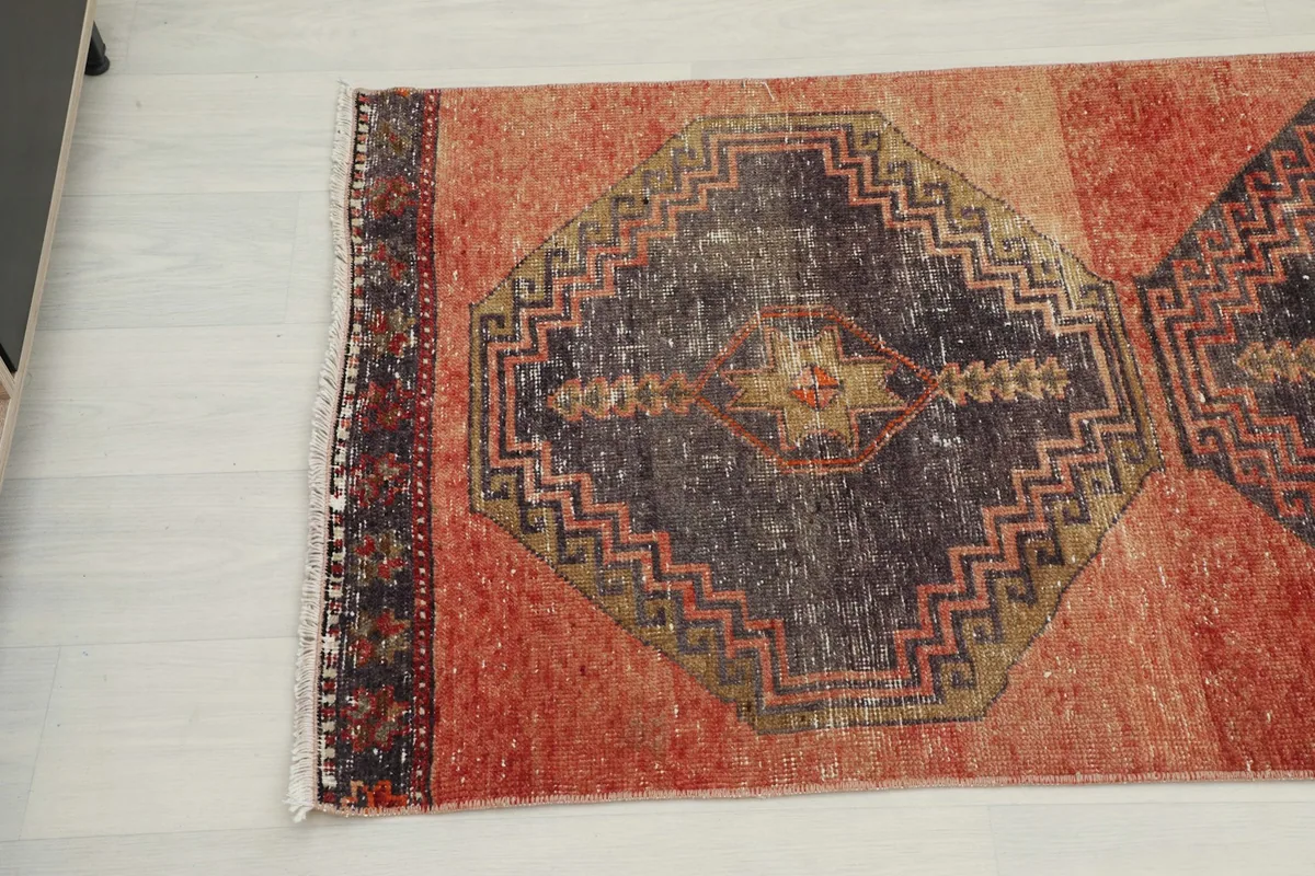 Angled view of the opposite end of the runner rug, showing the consistent pattern and colors