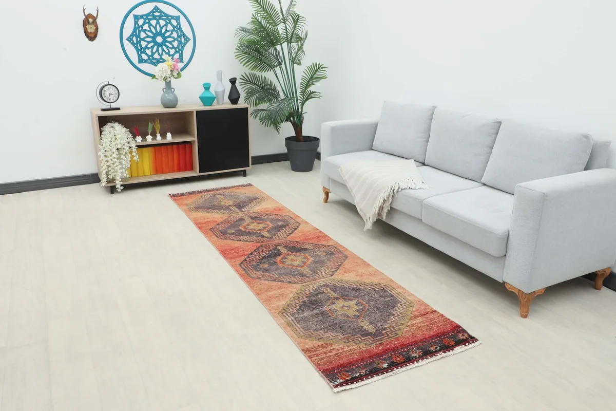Vintage runner rug displayed in a modern living space with a couch and console table