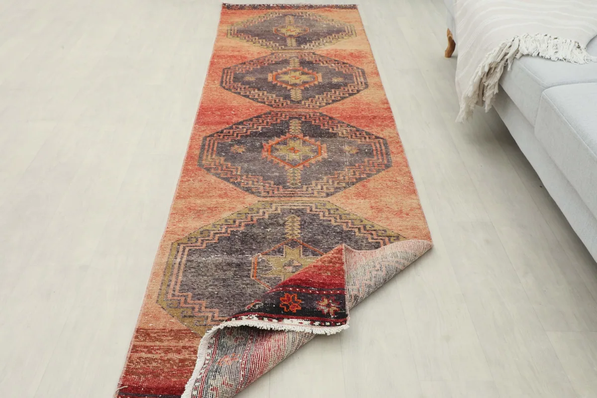 Runner rug with one end slightly folded, demonstrating flexibility and backing