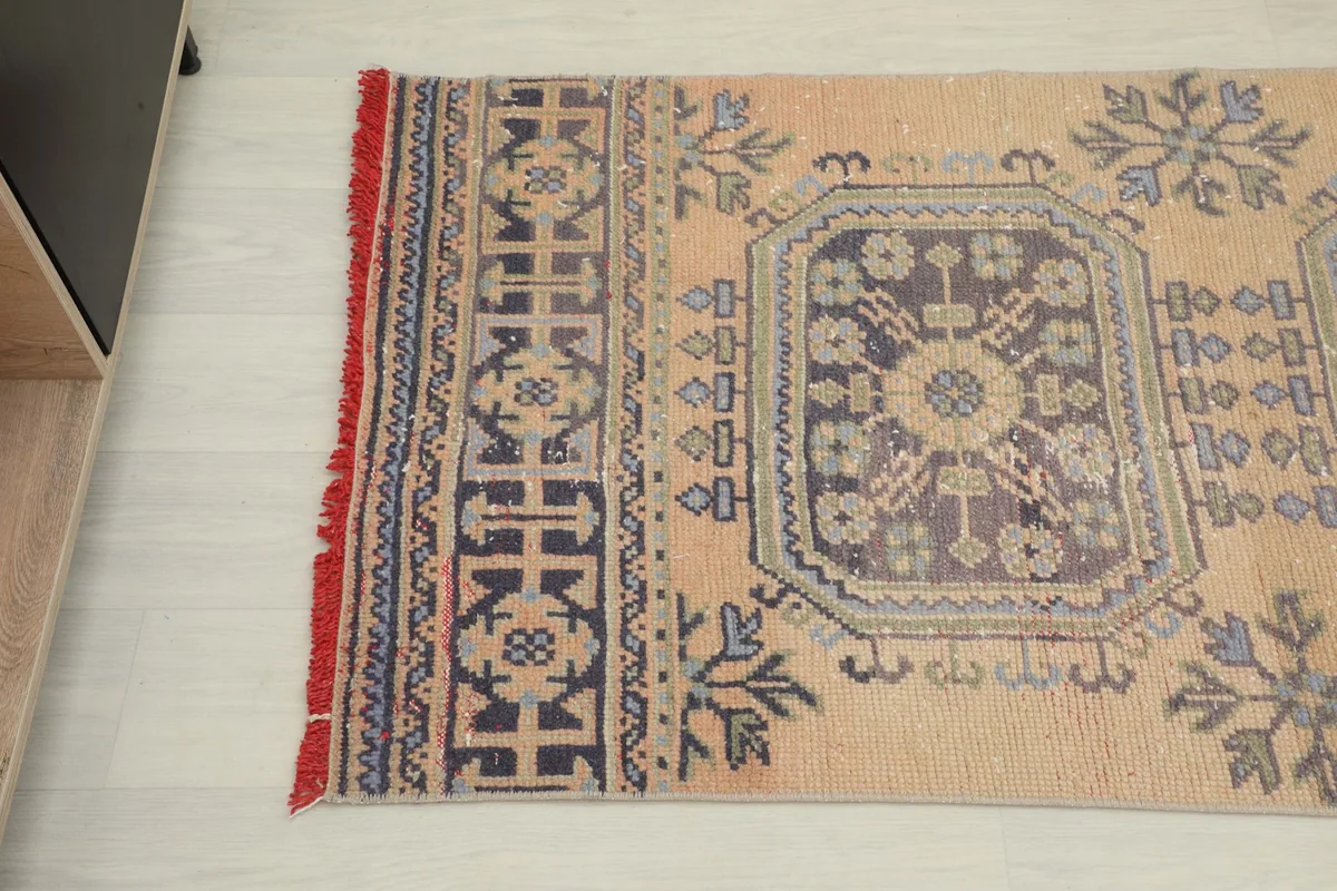 Detailed view of the blue geometric patterns and tribal border on the blush runner