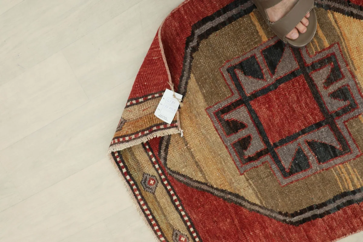 Underside of the rug, showing the hand-knotted construction and a small product tag.