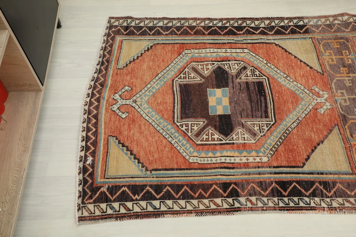 Angled view of the other end of the vintage runner, highlighting the intricate patterns