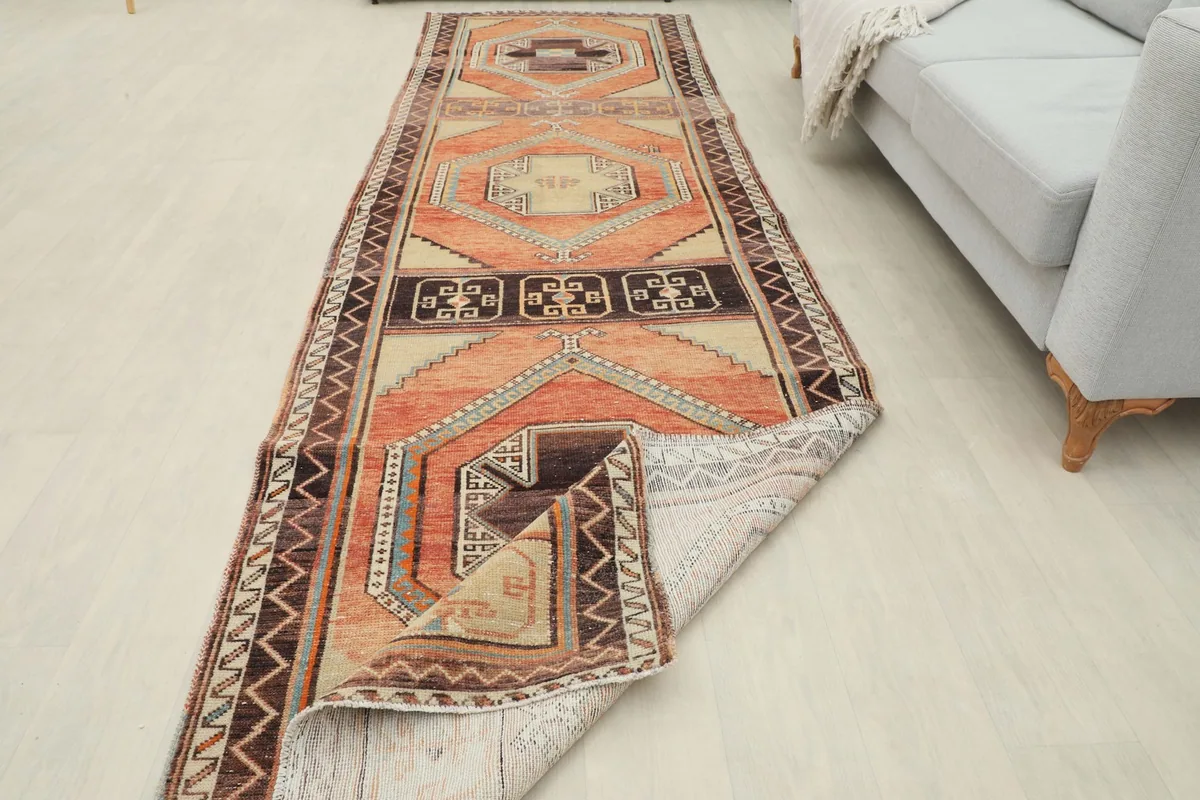 Runner rug partially folded to show its flexibility and thickness in a room setting