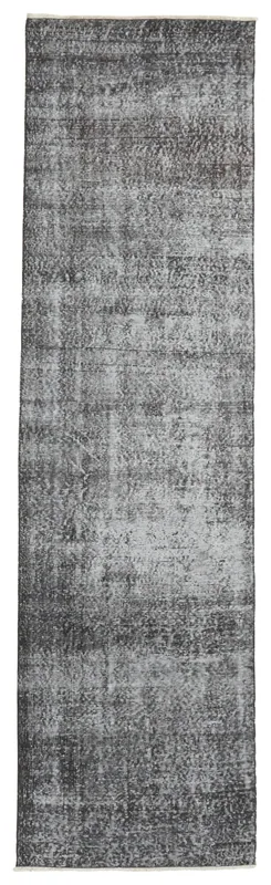 Full overhead view of the charcoal and gray vintage Anatolian runner rug on a white background.