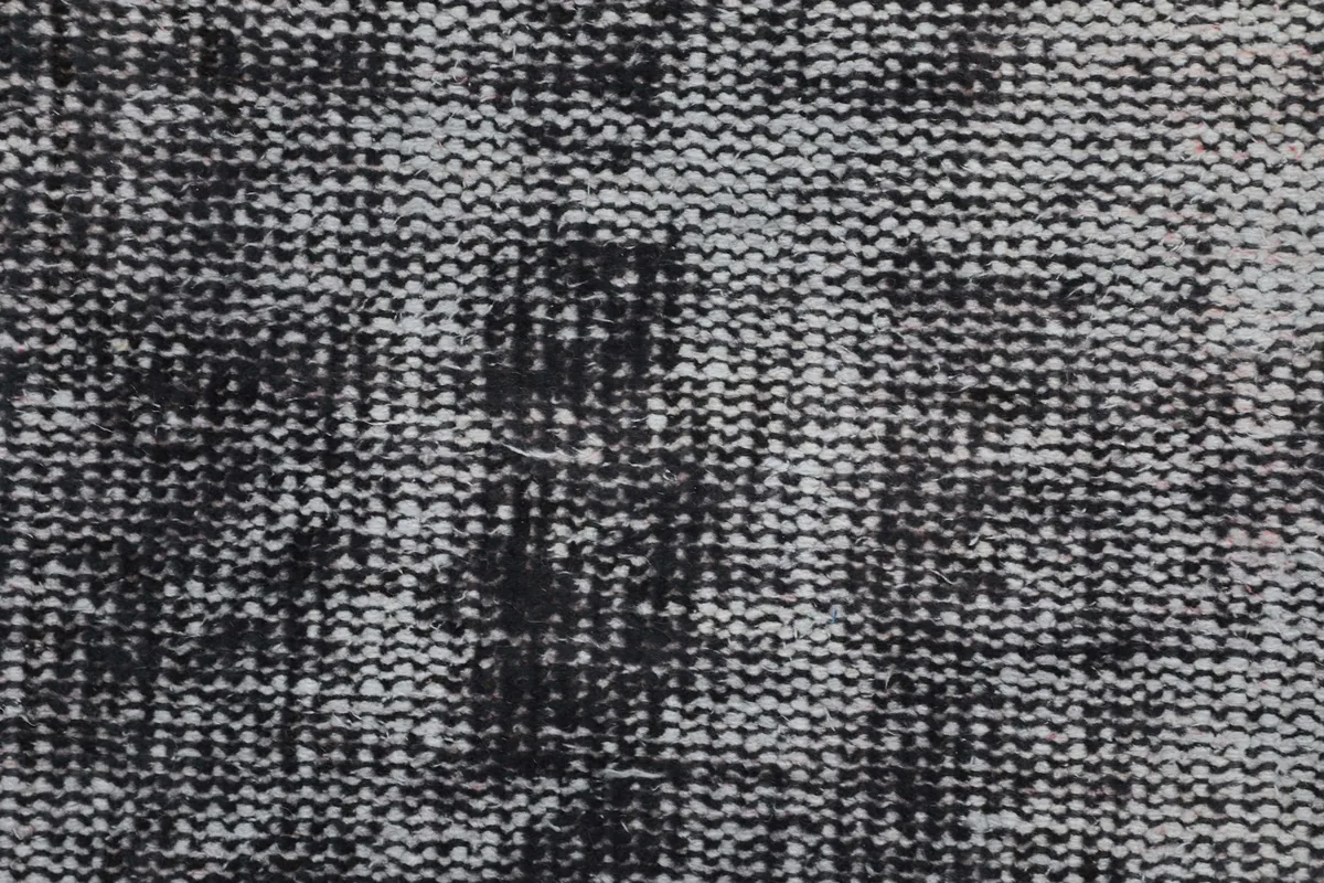 Extreme close-up of the low pile and intricate weave of the vintage wool runner rug