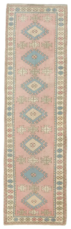 Full top view of the 2'11" x 10'10" vintage Anatolian runner rug with pink field and geometric pattern