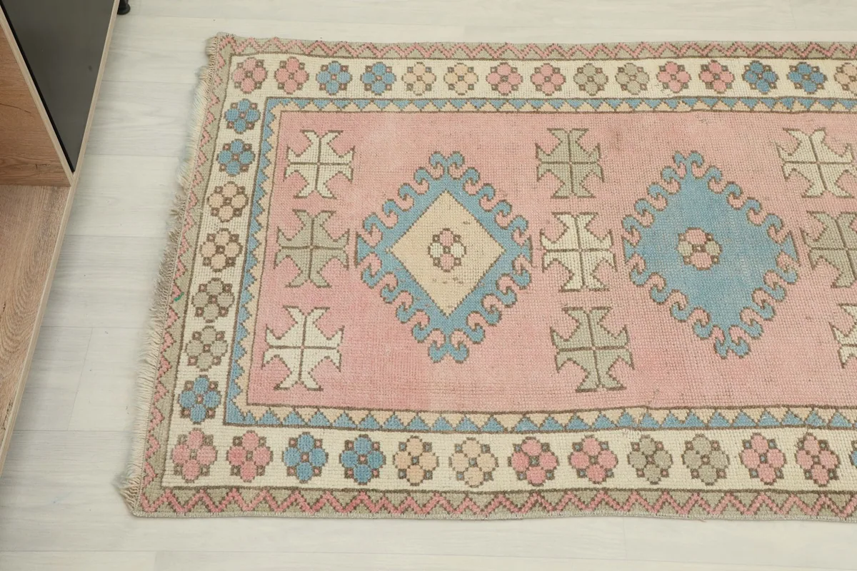 Close-up of one end of the vintage runner, highlighting the geometric patterns and border details