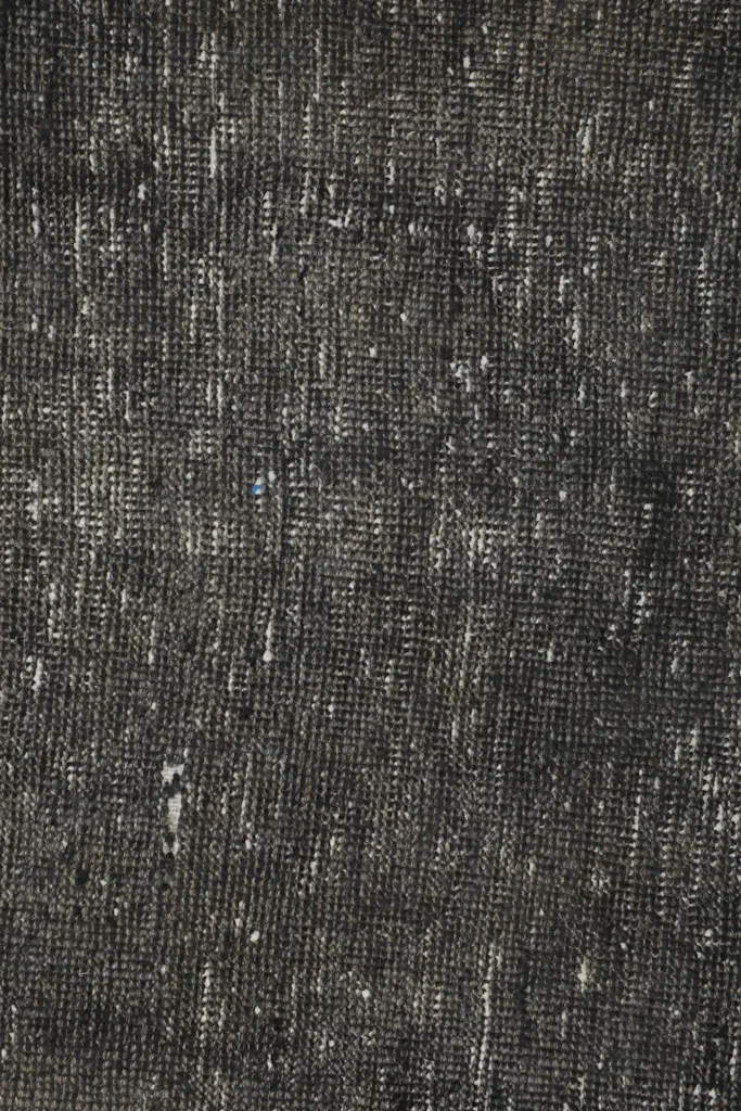 Detailed view of the low wool pile, showing the distressed texture and color variation
