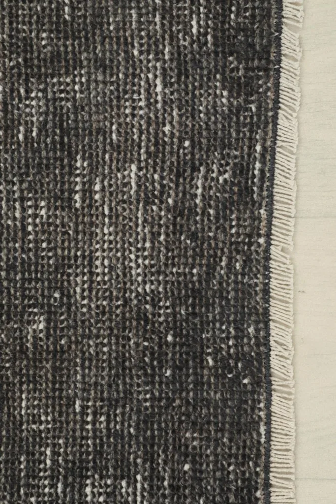 Close-up of the short, subtle fringes and edge of the vintage runner rug