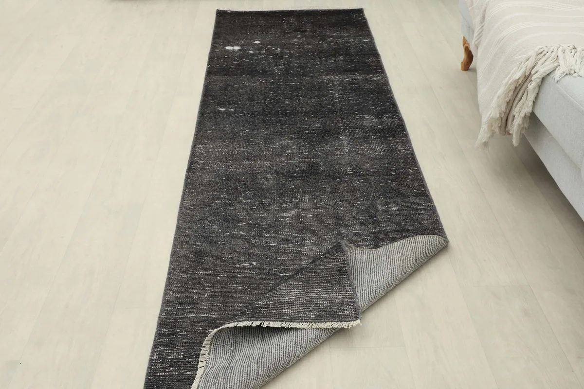 Runner rug partially folded, showcasing the cotton foundation and overall length