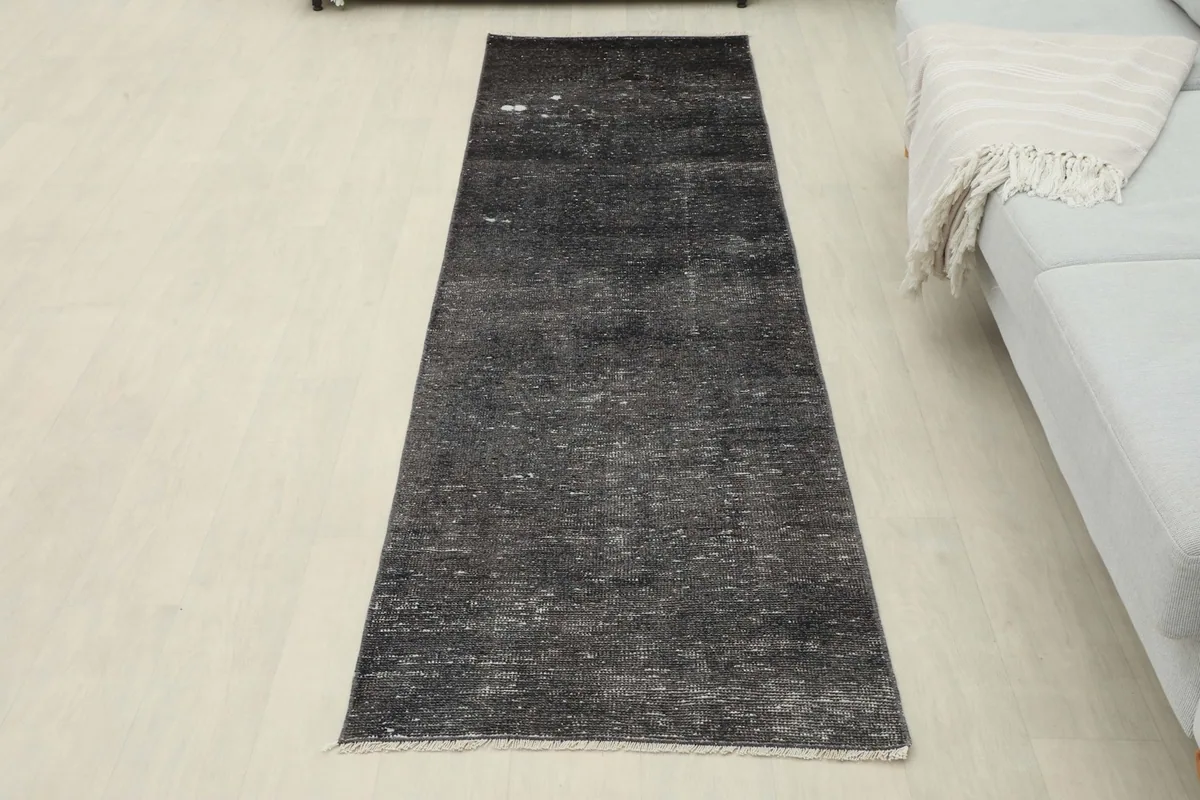Overhead view of the entire charcoal runner rug laid out in a room