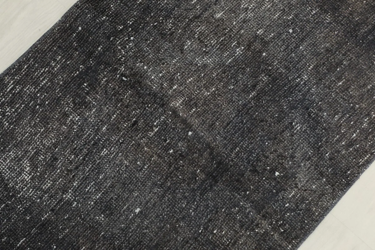 Detailed view of the low wool pile and subtle color shifts across the rug's surface