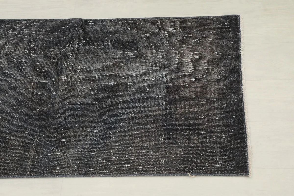 Overhead close-up showing the charcoal and gray color variations and distressed texture