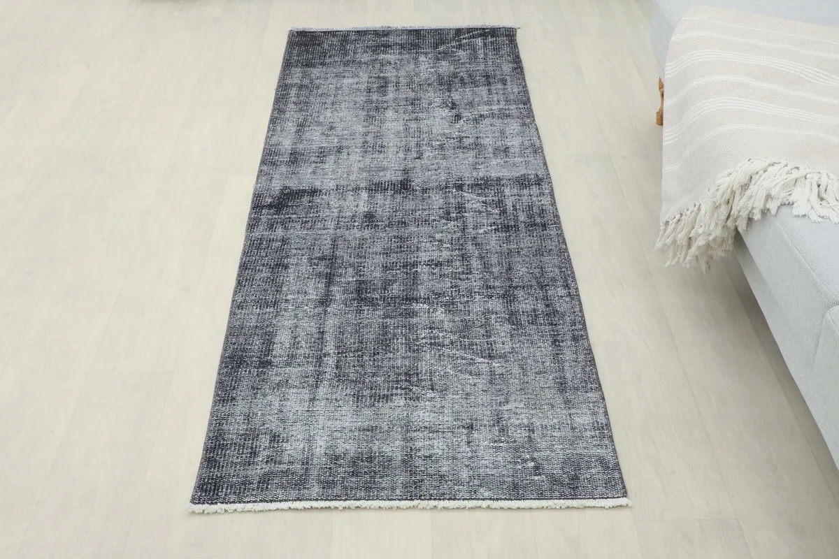 Full overhead view of the charcoal and gray vintage Anatolian runner rug in a room setting.