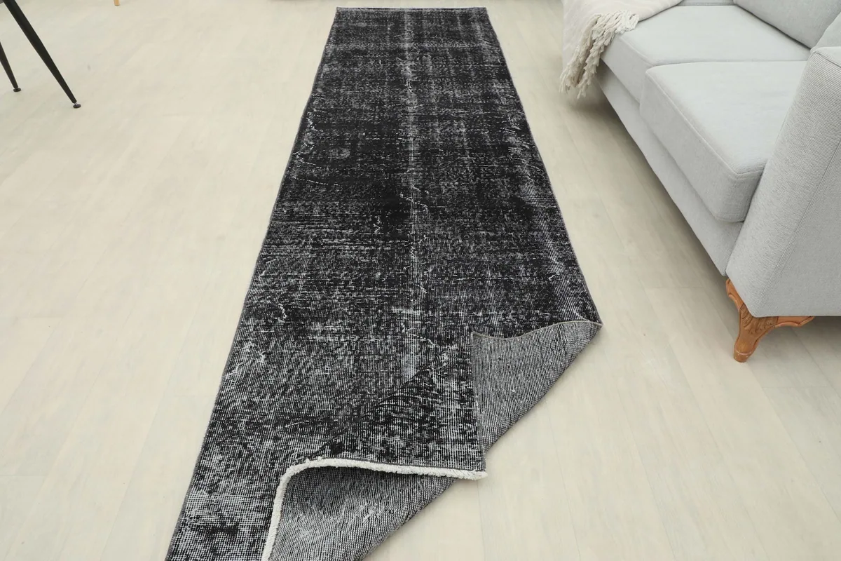 Runner rug with one end folded back, showcasing its flexibility and construction
