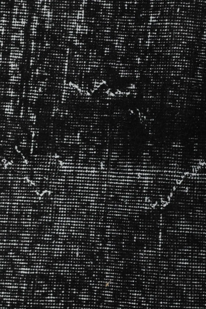 Macro shot of the low pile, showing individual knots and the distressed appearance