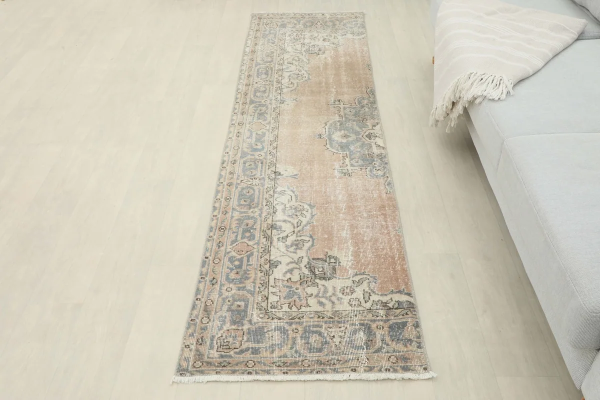 Full view of the tan and blue runner rug in a room setting, extending into the space